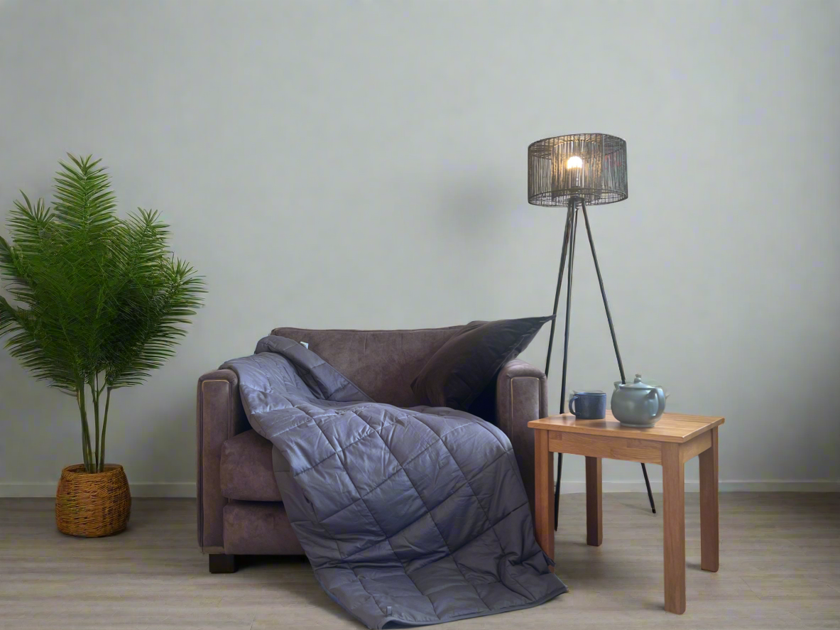 Cozy living room setup featuring a premium weighted blanket for ADHD on a sofa, promoting calm and relaxation.