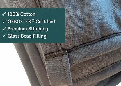 Close-up of premium weighted blanket showing 100% cotton, OEKO-TEX certification, and glass bead filling details.